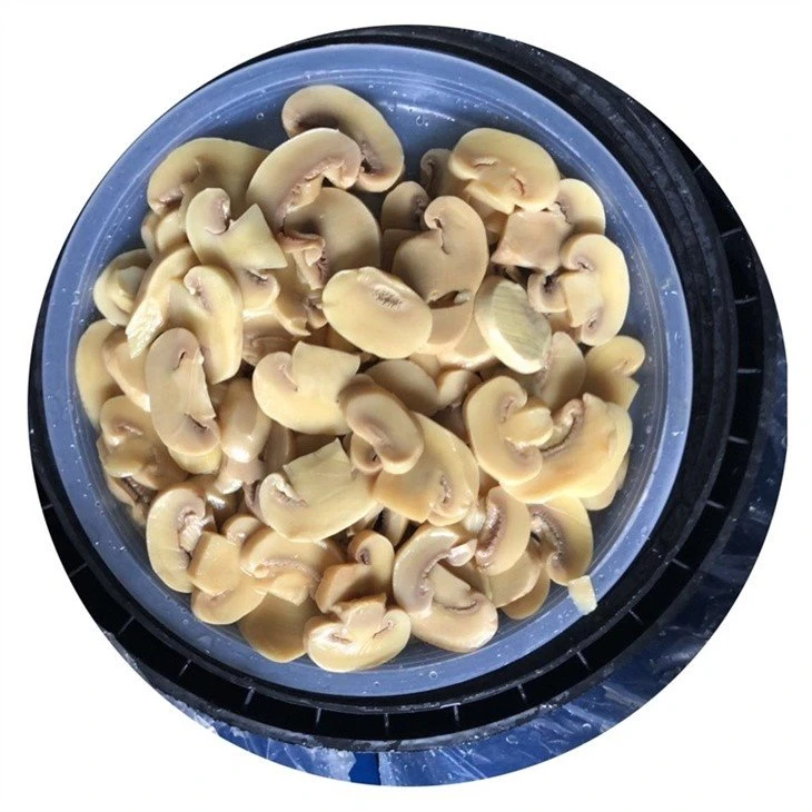 Sliced champignon mushroom in drums