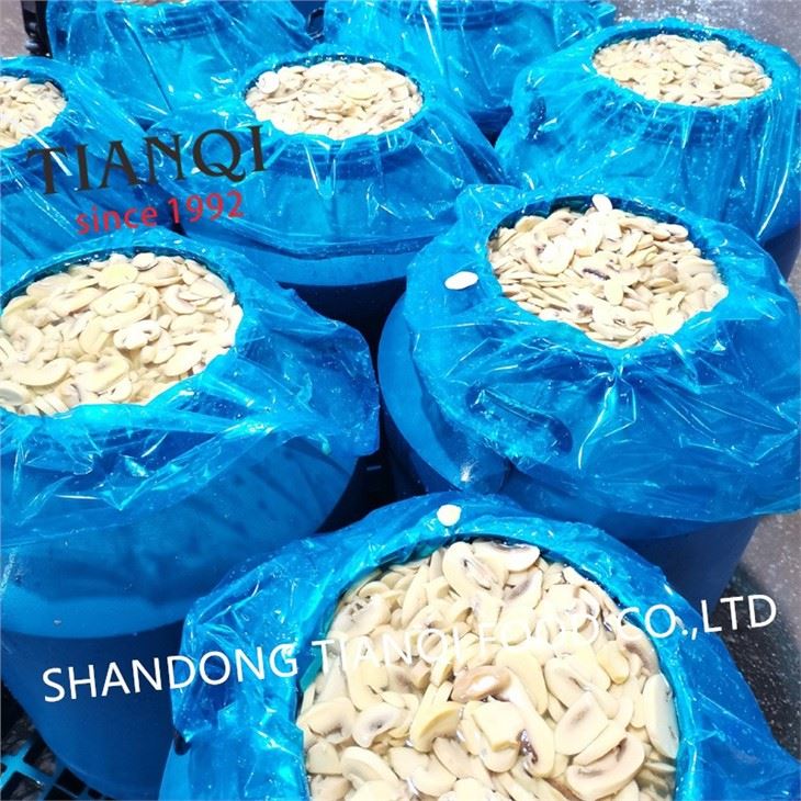 Fresh white champignon mushroom in barrel